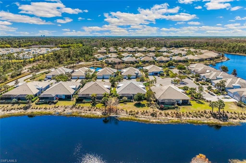 Aerial view of residential area featuring a nearby body of water