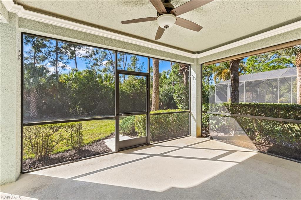 Unfurnished sunroom featuring a ceiling fan