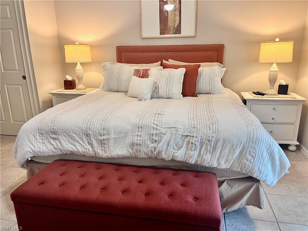 Owners Bedroom with King bed featuring light tile floors