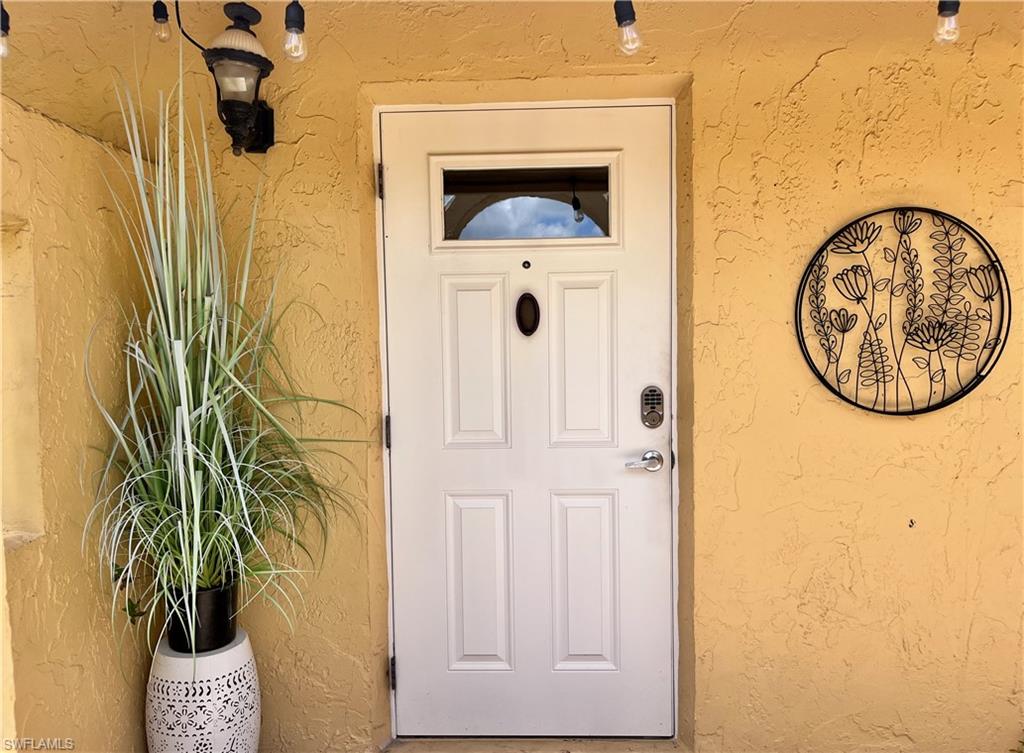 Doorway to property with stucco siding