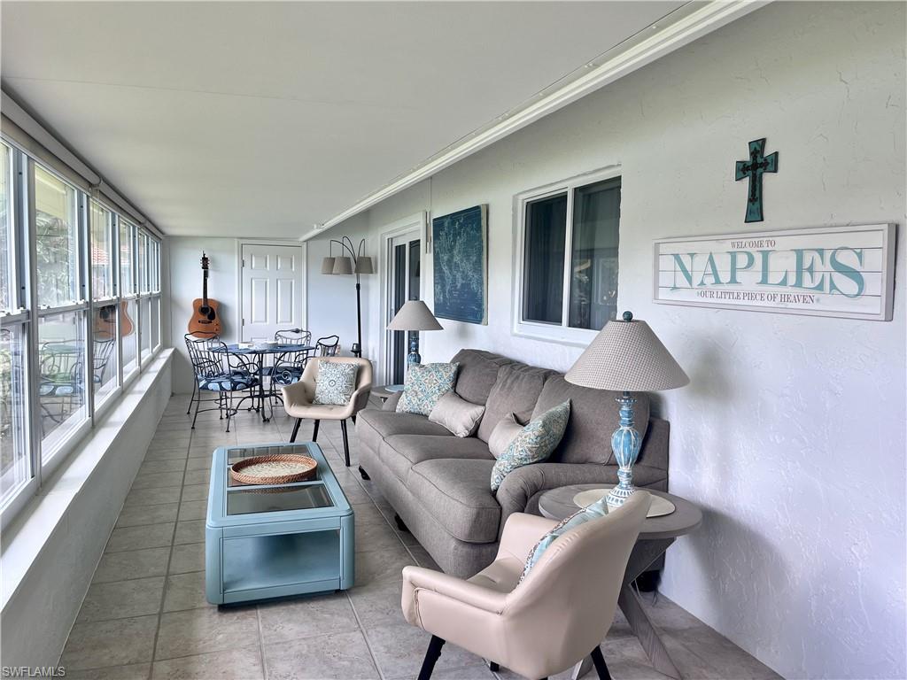 Sunroom with ornamental molding and tile patterned floors
