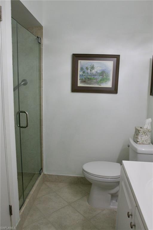 Guest bathroom with vanity, tile flooring, and toilet