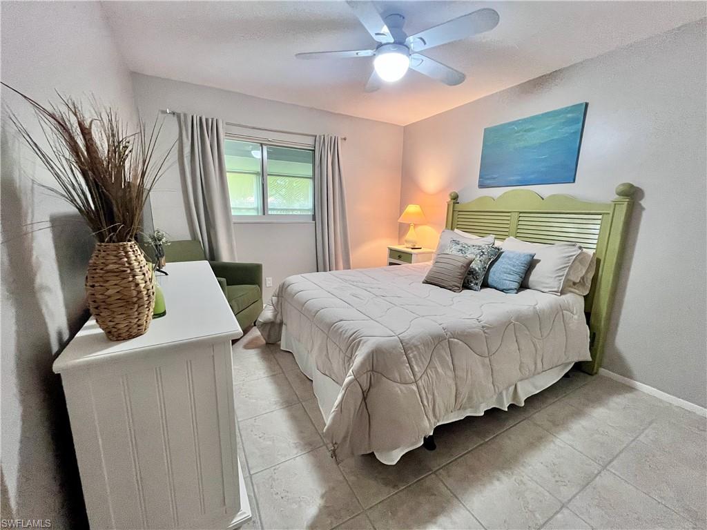 Guest Bedroom featuring Queen Bed, ceiling fan and light tile floors