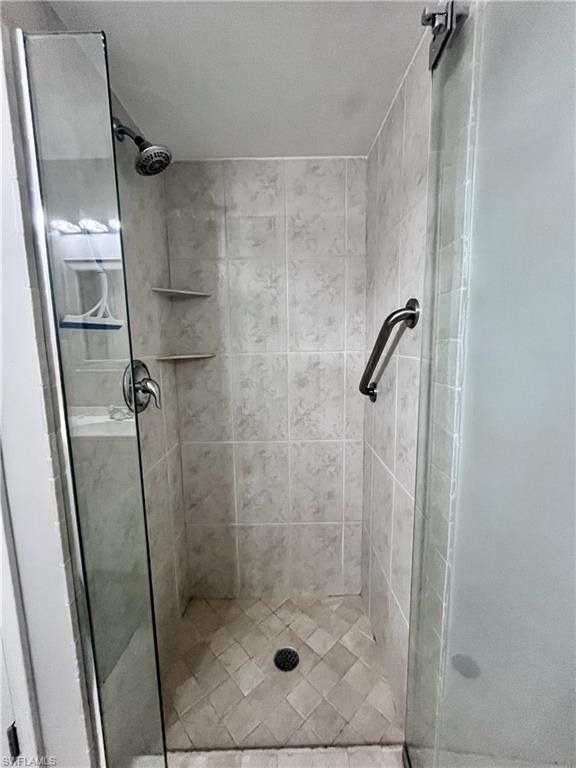 Full bath featuring a shower stall
