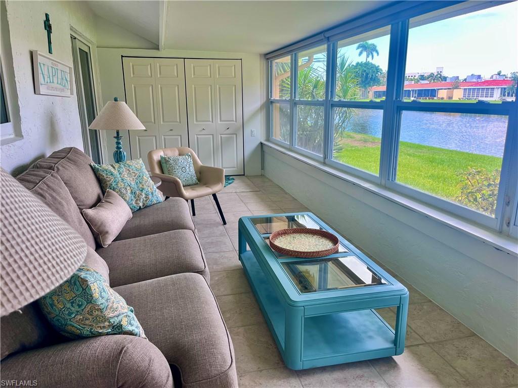 Sunroom featuring a water view