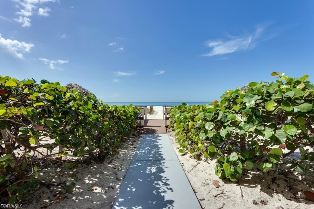 View of patio featuring view of water and beach