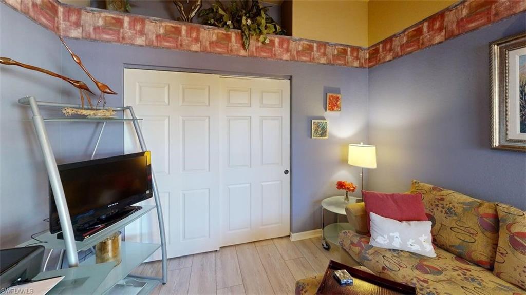 Living area with light wood finished floors and baseboards