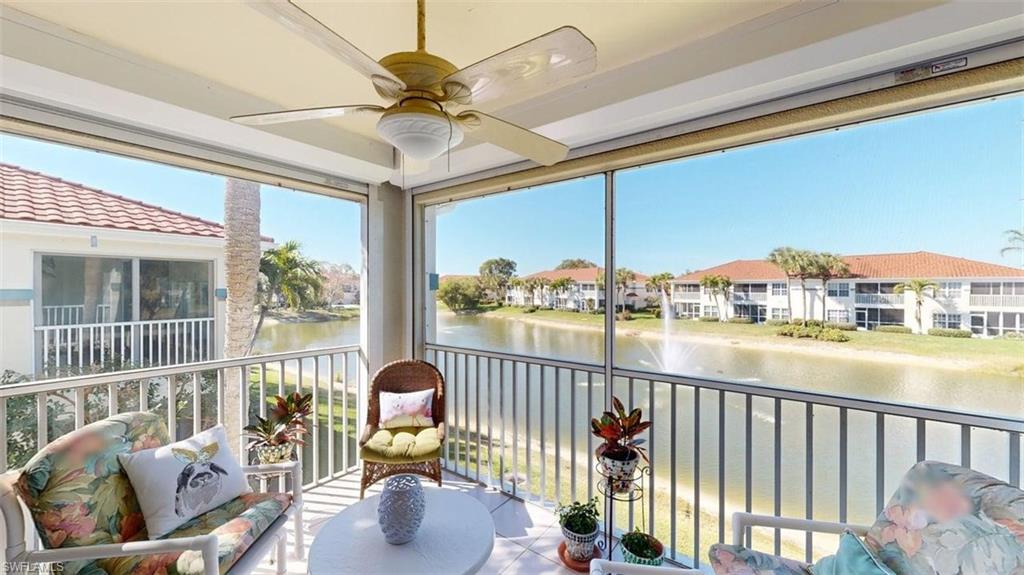 Sunroom featuring a water view
