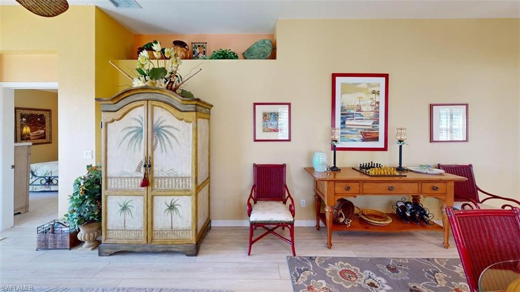Living area with wood finished floors and baseboards