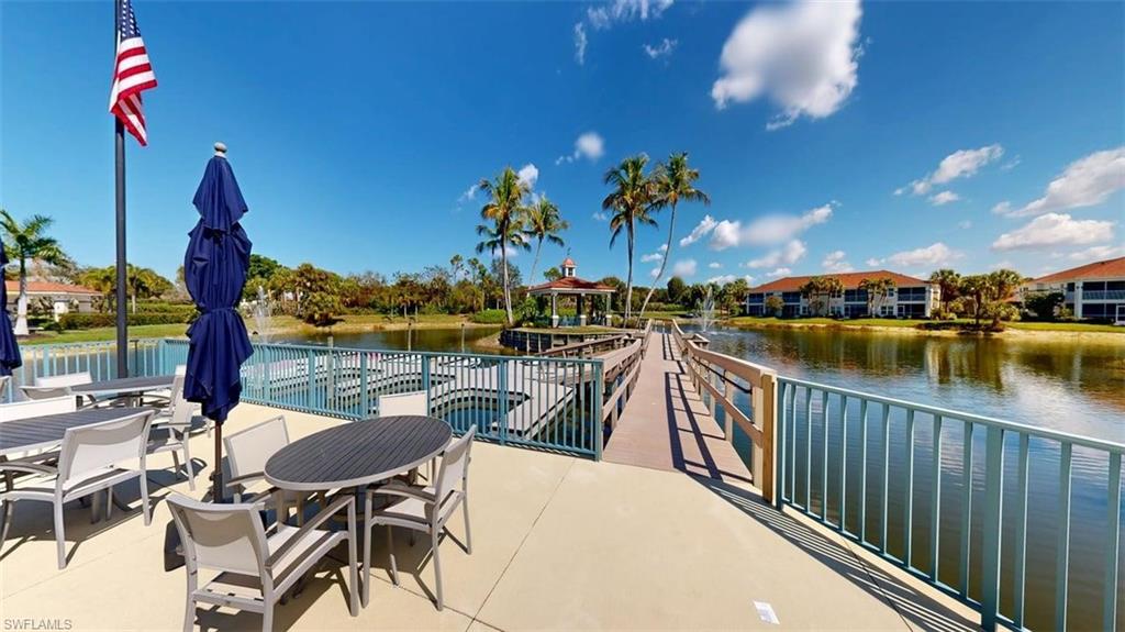 Dock area featuring a water view, outdoor dining space, and a gazebo