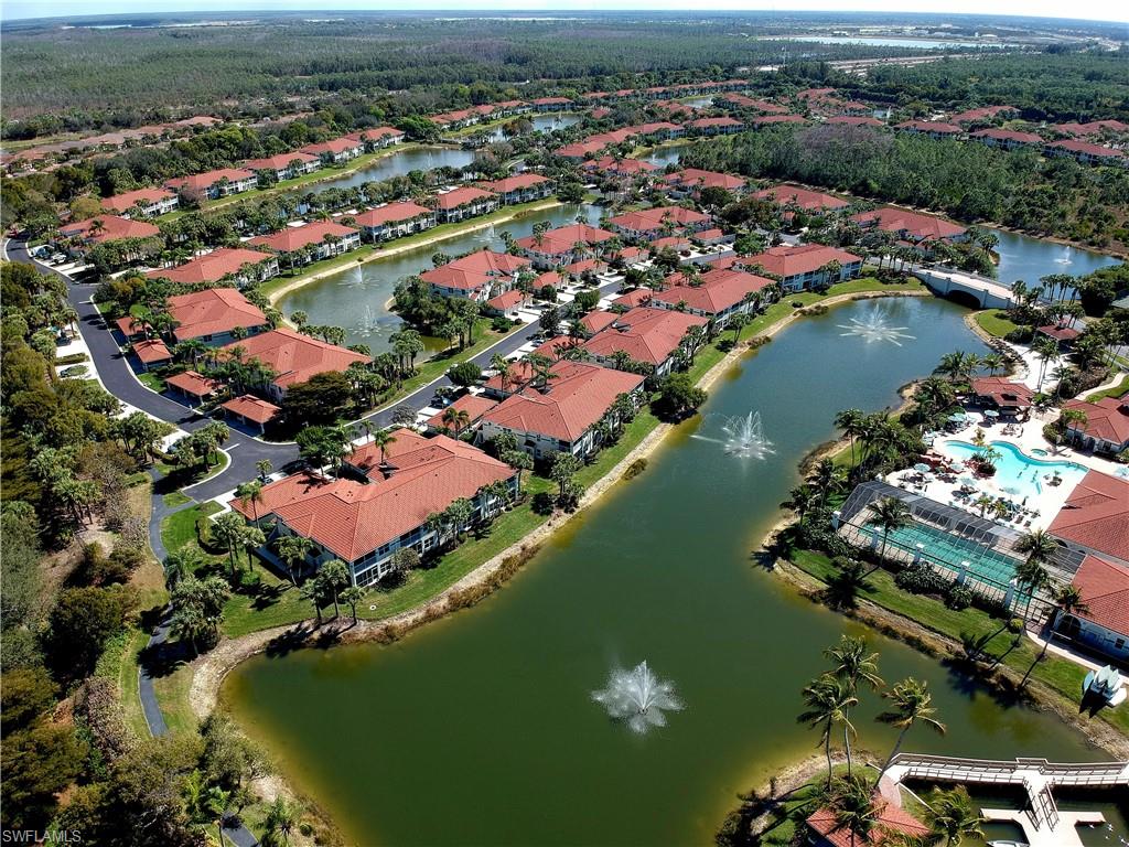 Aerial view of property and surrounding area with nearby suburban area and a nearby body of water