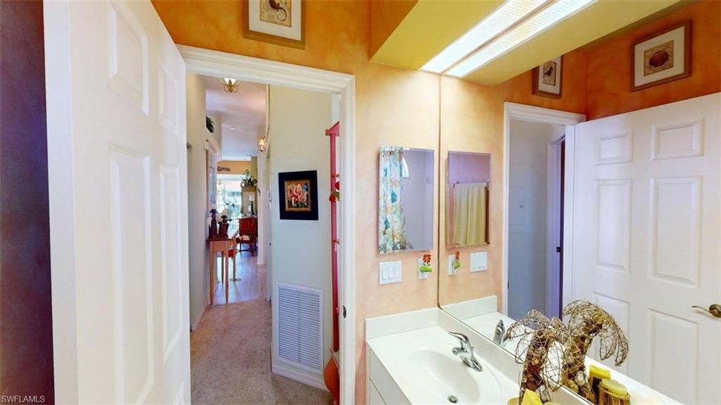 Bathroom featuring vanity and carpet floors