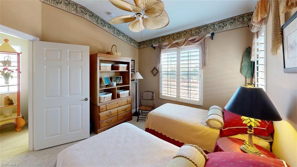 Bedroom with carpet and a ceiling fan