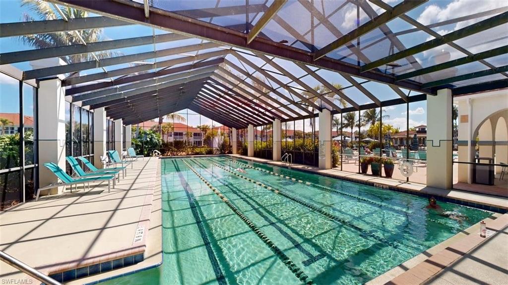 Community pool featuring a patio area and glass enclosure