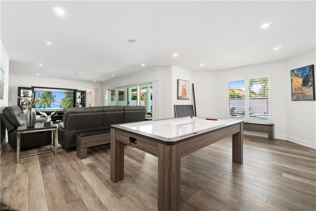 Game room with light wood-type flooring and recessed lighting