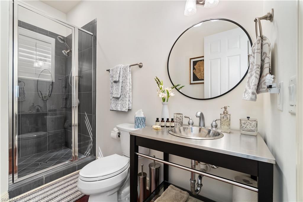 Full bathroom with toilet and a stall shower