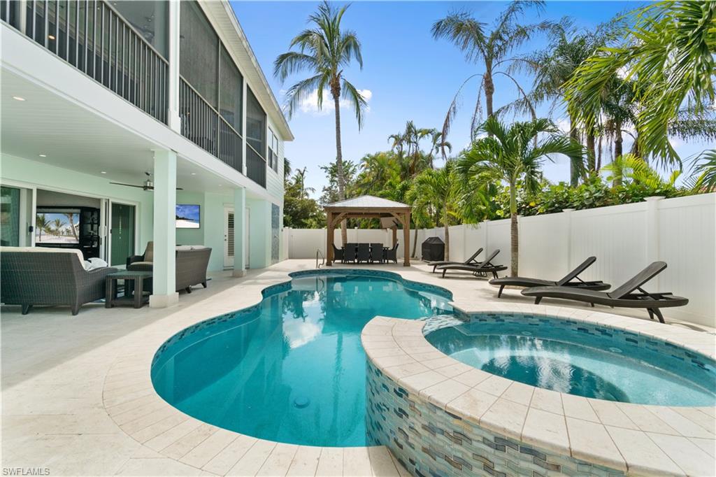 Integrated pool / spa featuring a patio area, an outdoor lounge area, a balcony, and a gazebo