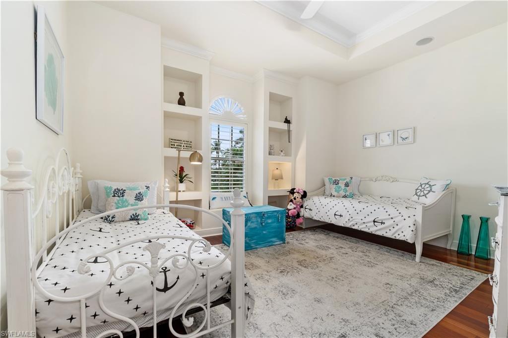 Bedroom featuring crown molding, wood finished floors, and ceiling fan