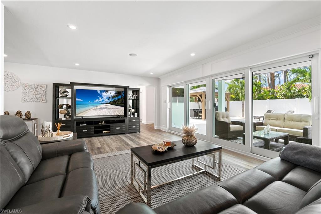 Living room with wood finished floors and recessed lighting