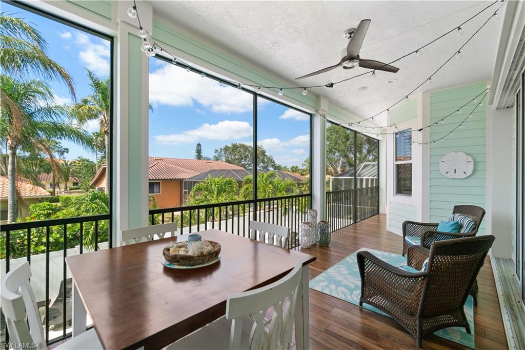 Sunroom / solarium featuring outdoor dining area and a ceiling fan