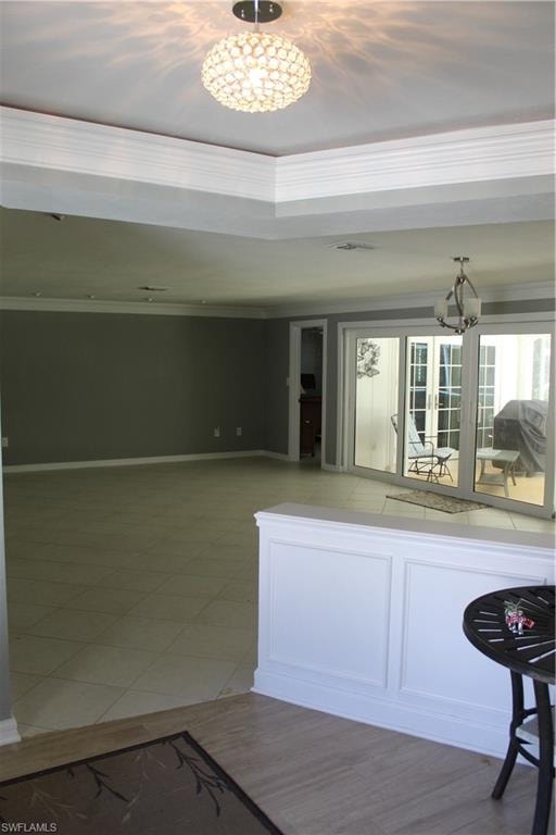 Kitchen featuring a chandelier and baseboards