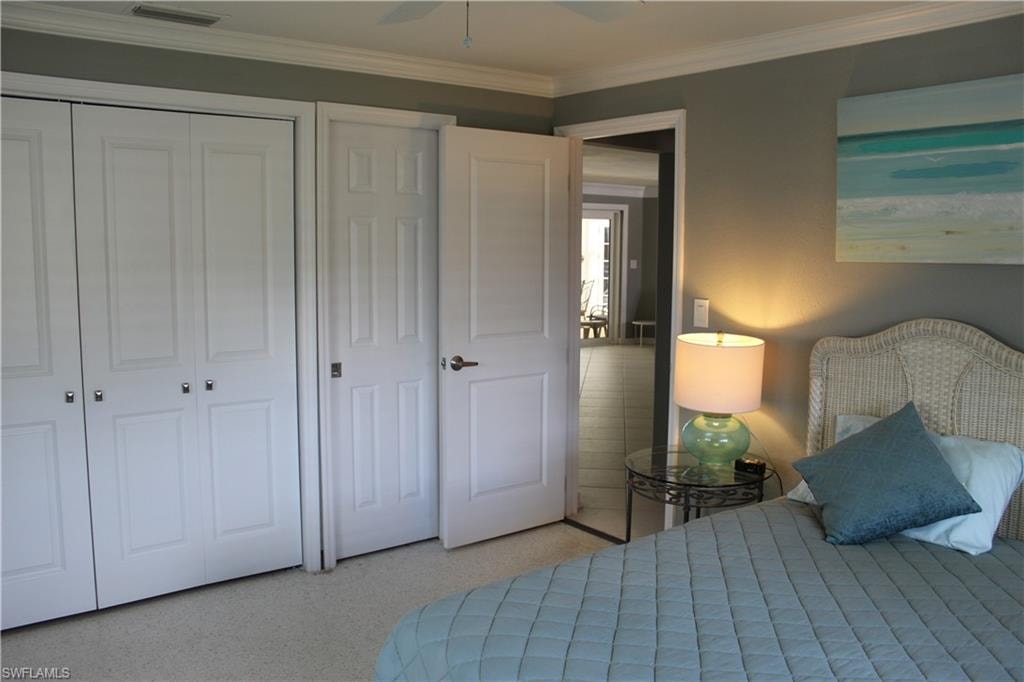 Bedroom with crown molding, a closet, and a ceiling fan