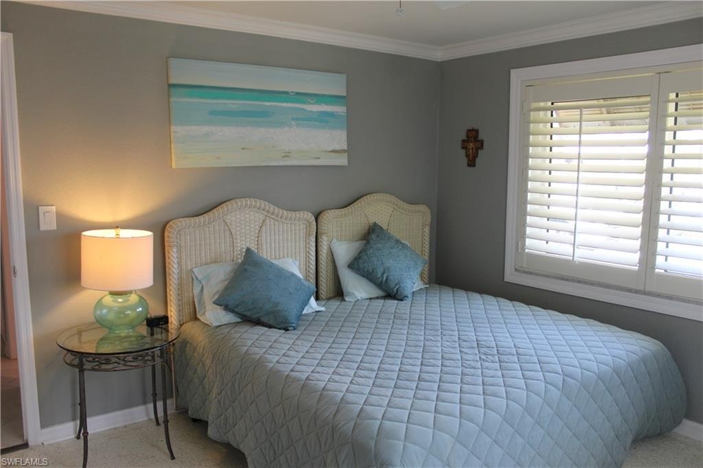 Bedroom featuring ornamental molding and a ceiling fan