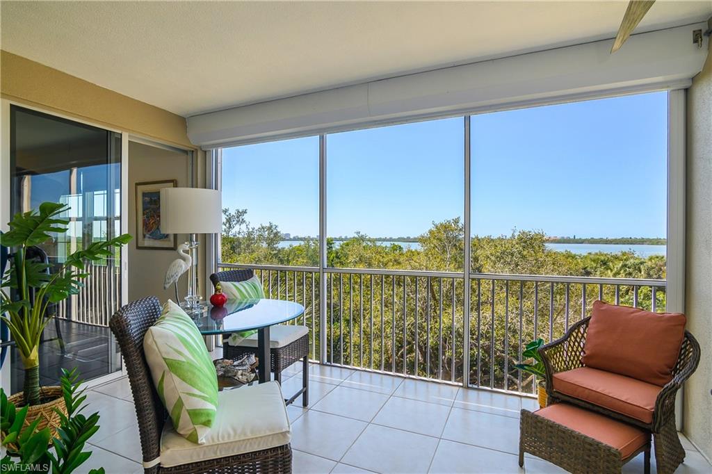 Sunroom featuring a water view