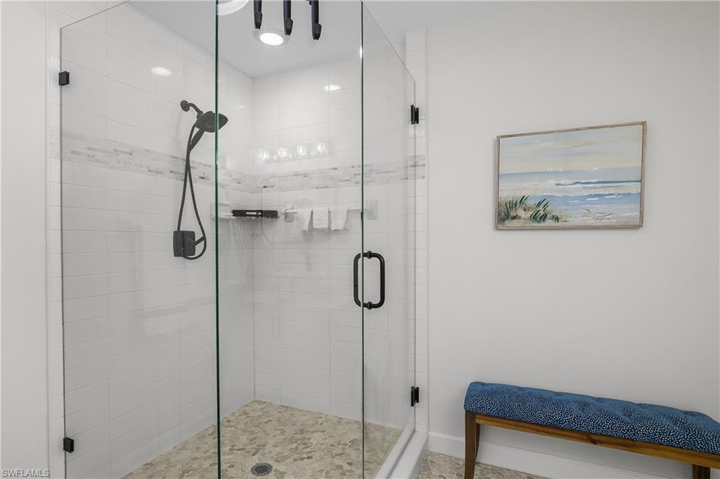 Full bath featuring a shower stall