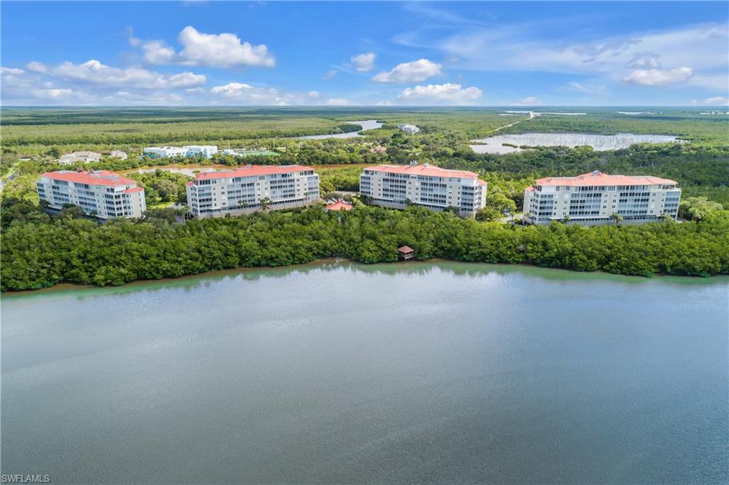 Bird's eye view of apartment complex and a nearby body of water