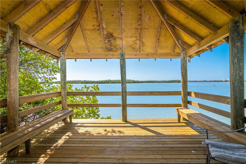Dock featuring a gazebo and a deck with water view