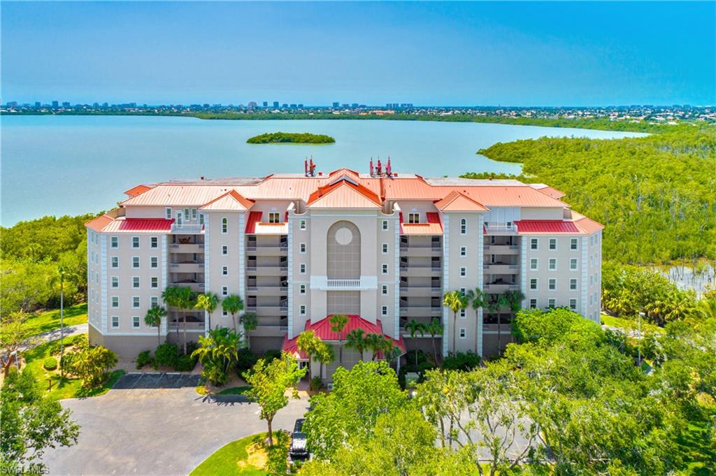 Aerial view of apartment complex and a large body of water
