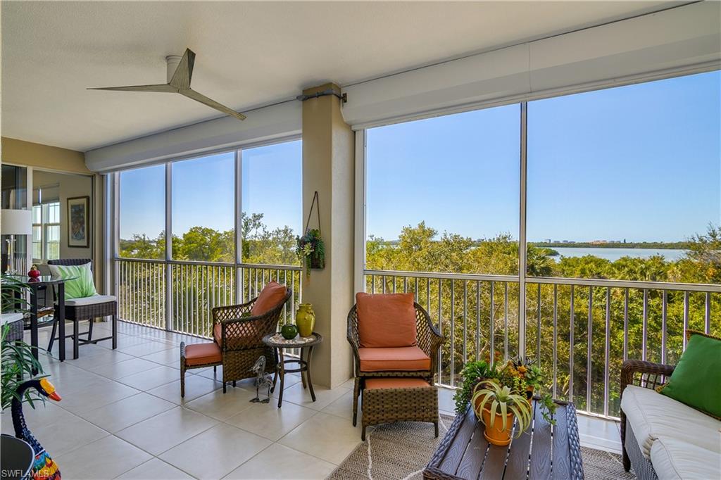 Sunroom with tile patterned floors and a water view