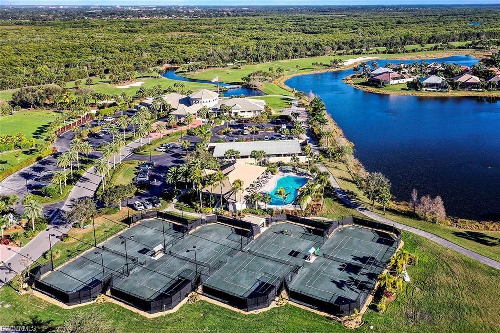 Aerial perspective of suburban area with a large body of water and a pool
