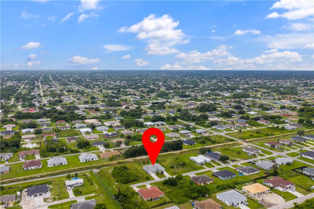 Aerial view of property's location featuring nearby suburban area