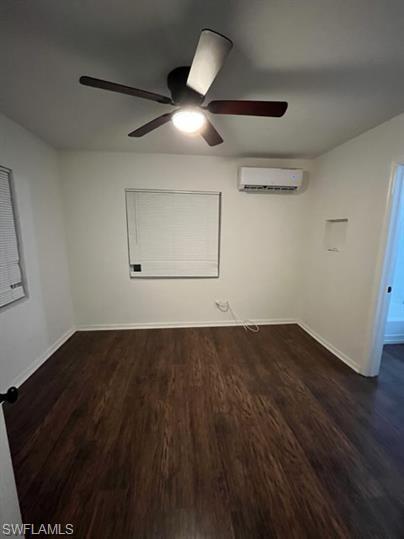Spare room featuring dark wood finished floors and ceiling fan