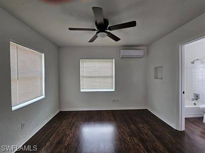 Spare room with dark wood-style flooring and a ceiling fan
