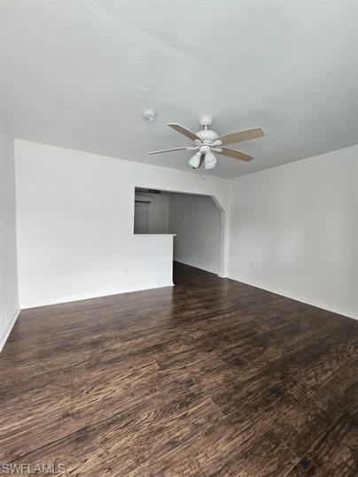 Spare room with dark wood-style floors and ceiling fan