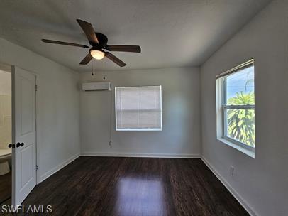 Unfurnished bedroom with dark wood-style flooring and ceiling fan