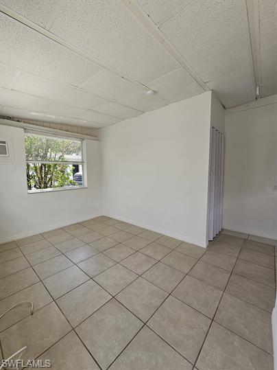 Unfurnished room with light tile patterned floors