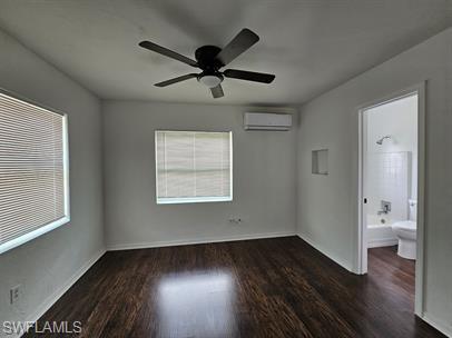 Unfurnished bedroom with dark wood-style flooring and a ceiling fan