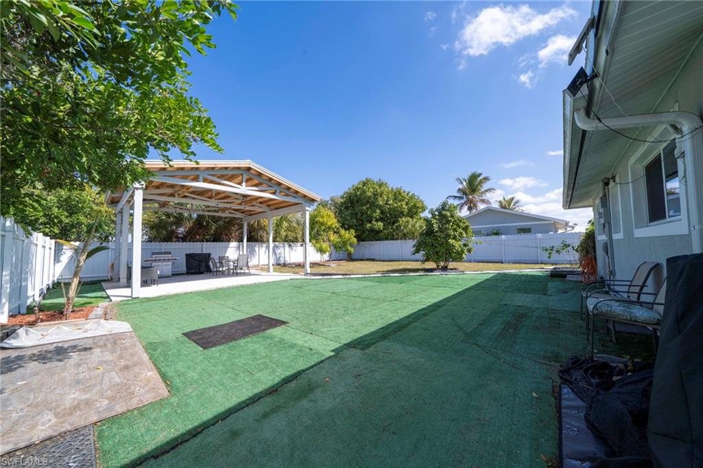 Fenced backyard with a patio area