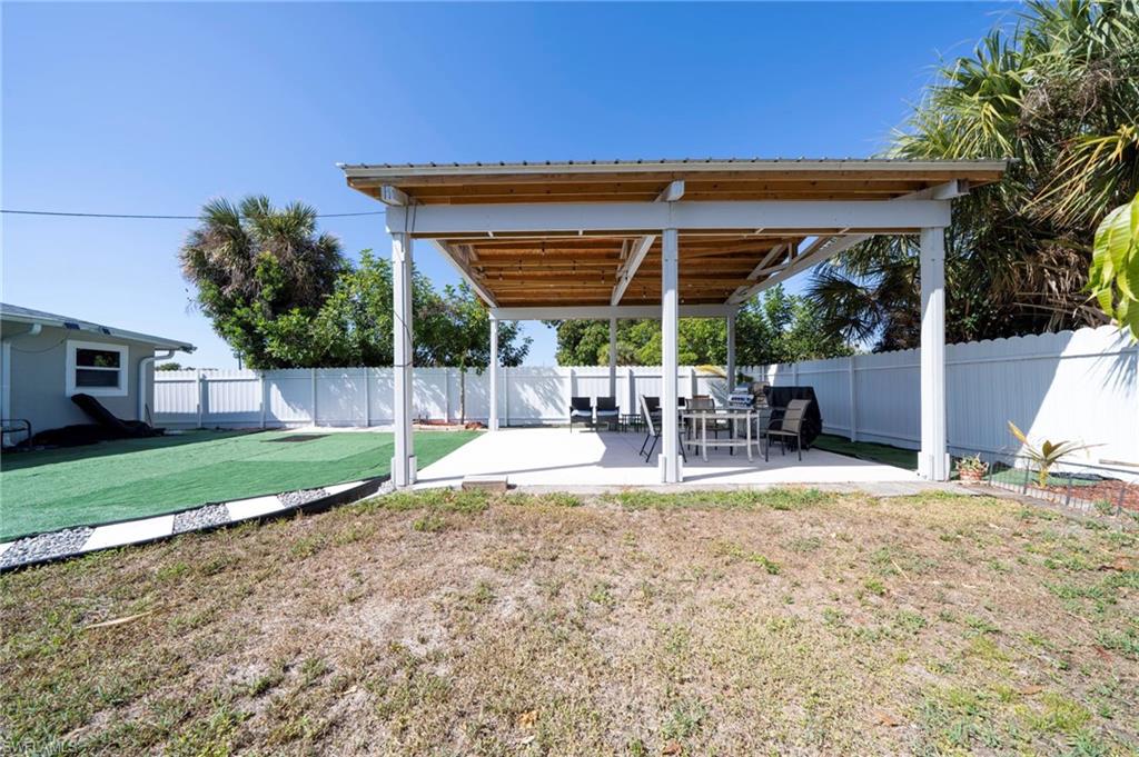 Fenced backyard with a patio area