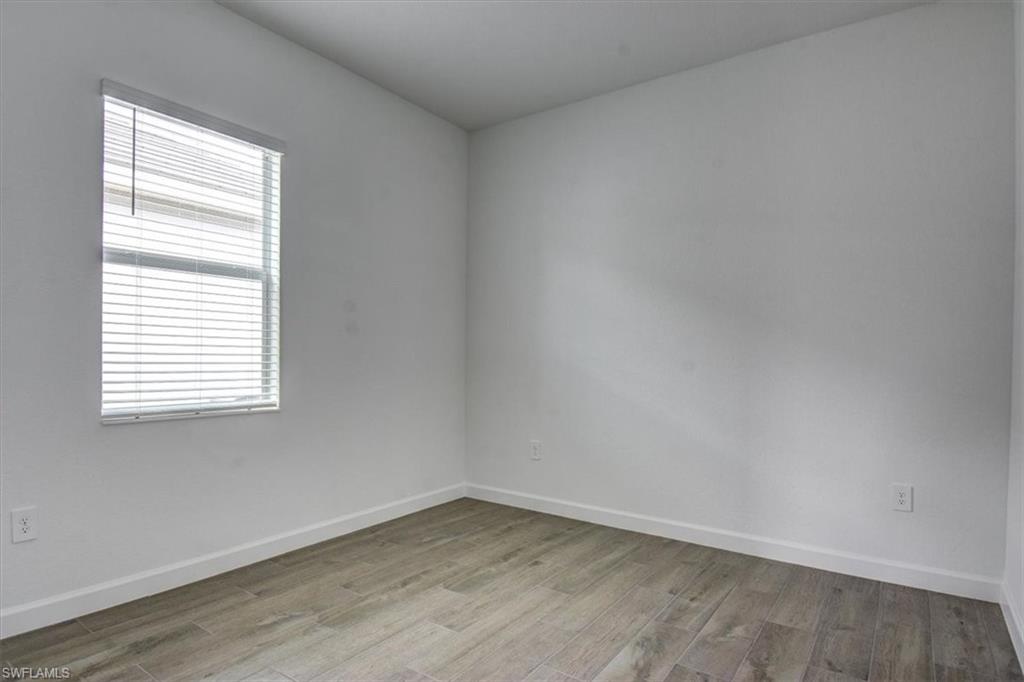 Unfurnished room featuring baseboards and light wood-type flooring