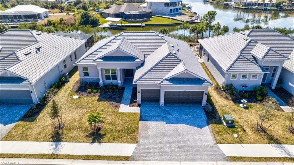 Aerial perspective of suburban area featuring a large body of water