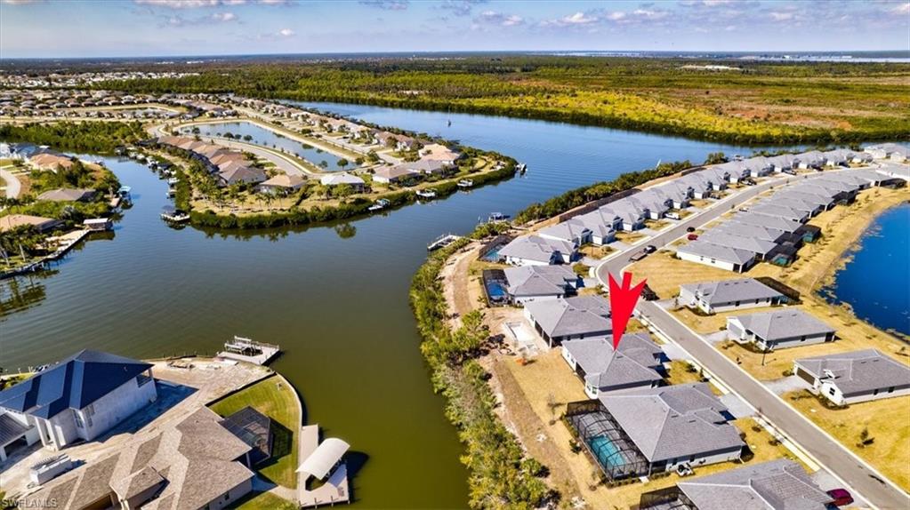 Aerial view of property's location with nearby suburban area and a large body of water