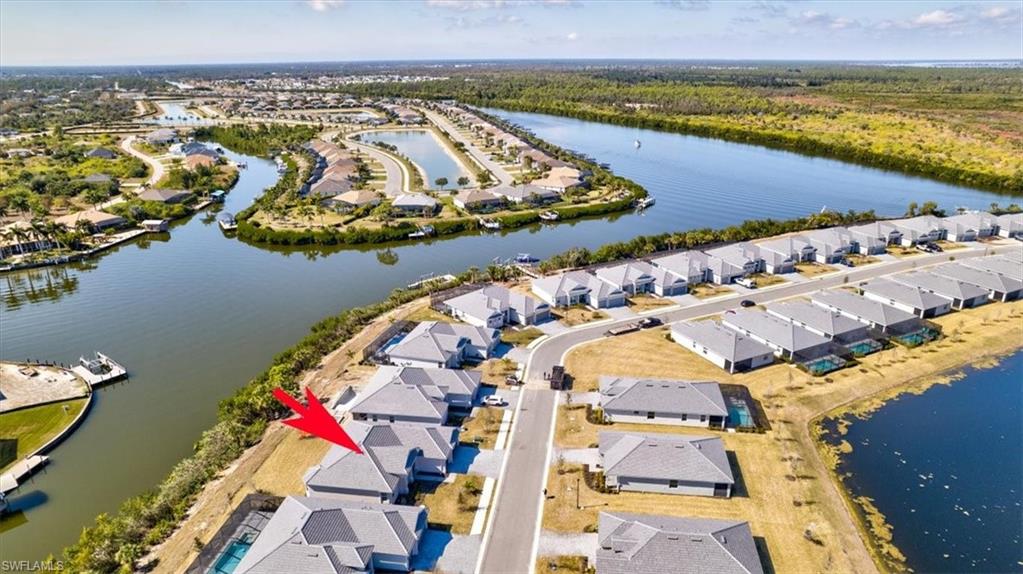 Aerial view of property's location with nearby suburban area and a large body of water