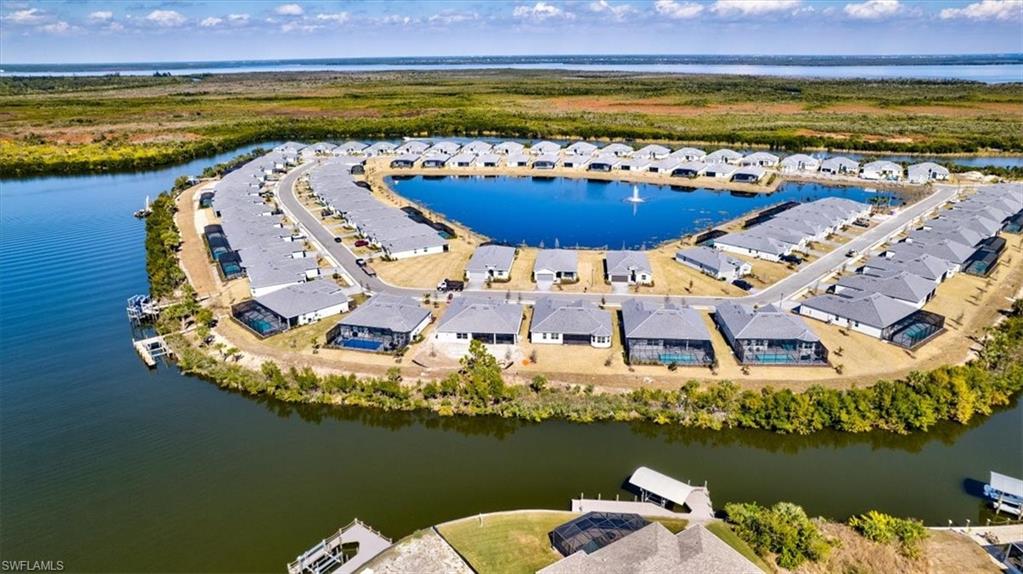 Aerial view of residential area featuring a large body of water