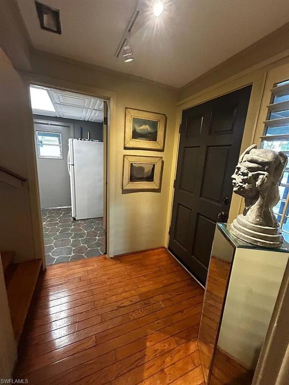 Hallway with light wood-style floors
