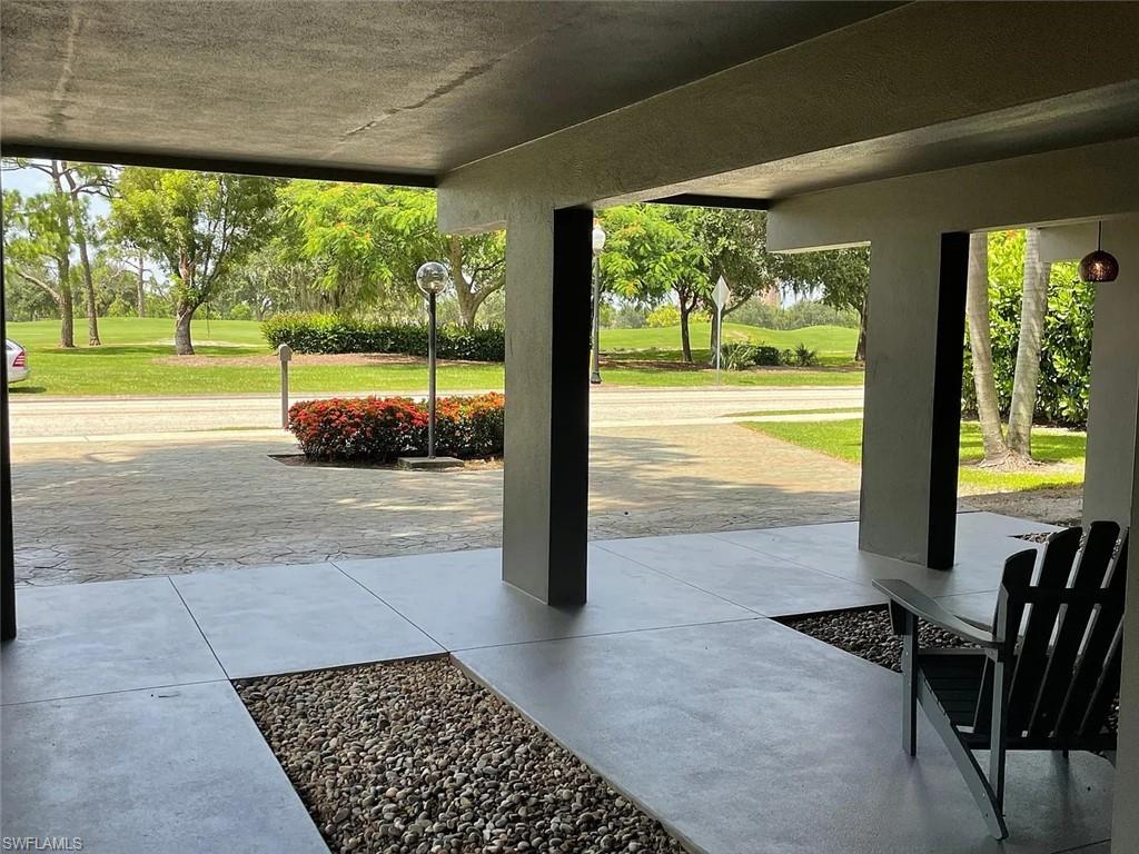 Porch featuring a lawn